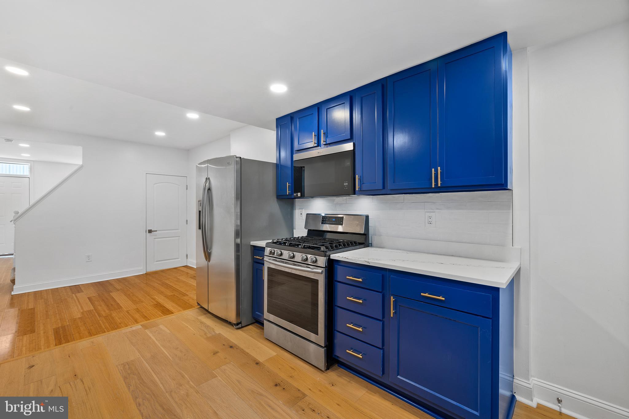 a kitchen with wooden cabinets and stainless steel appliances