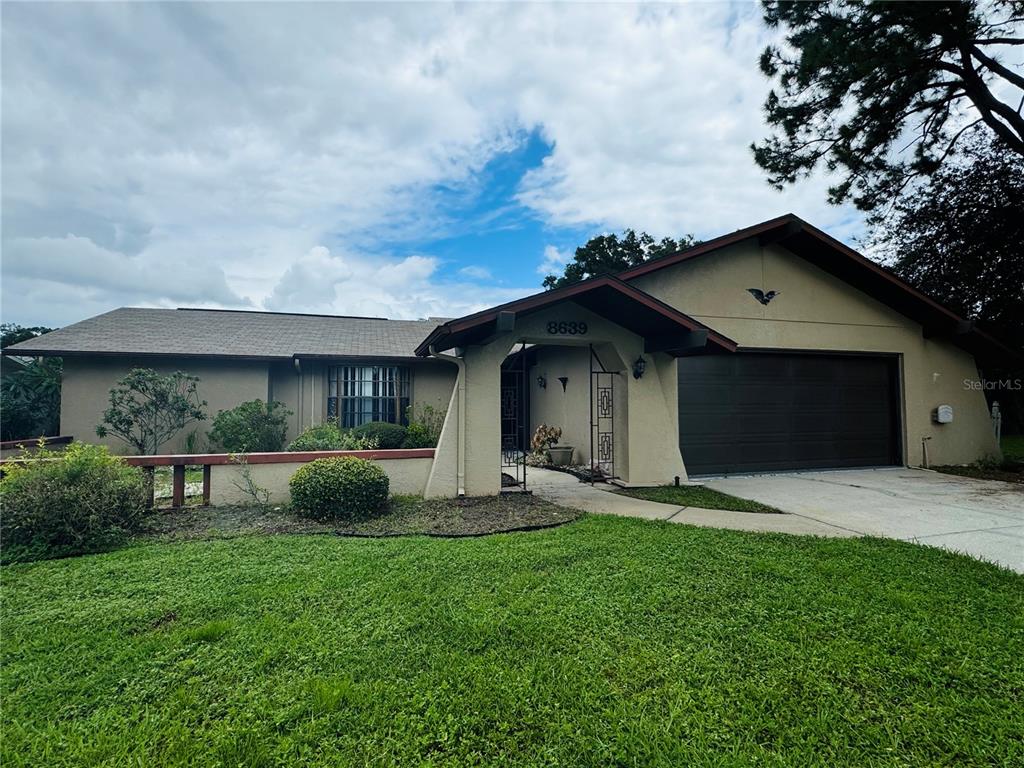 a front view of a house with a yard and garage