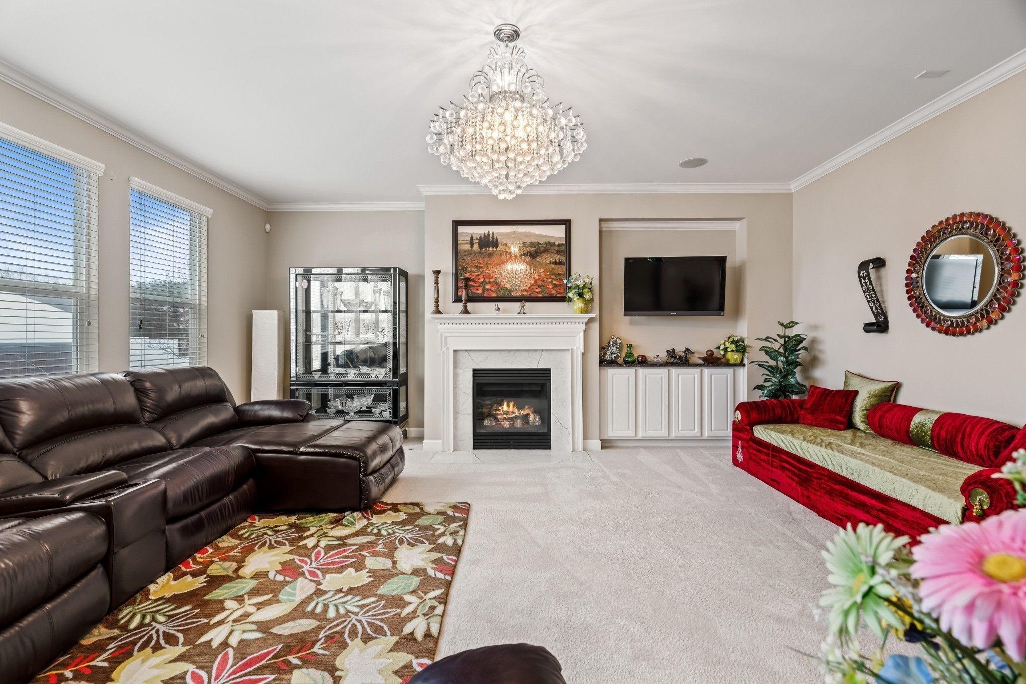 a living room with furniture a flat screen tv and a fireplace