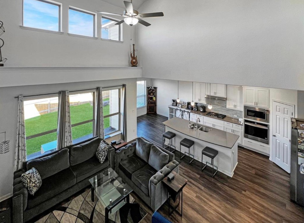 a kitchen with stainless steel appliances a stove a sink and cabinets