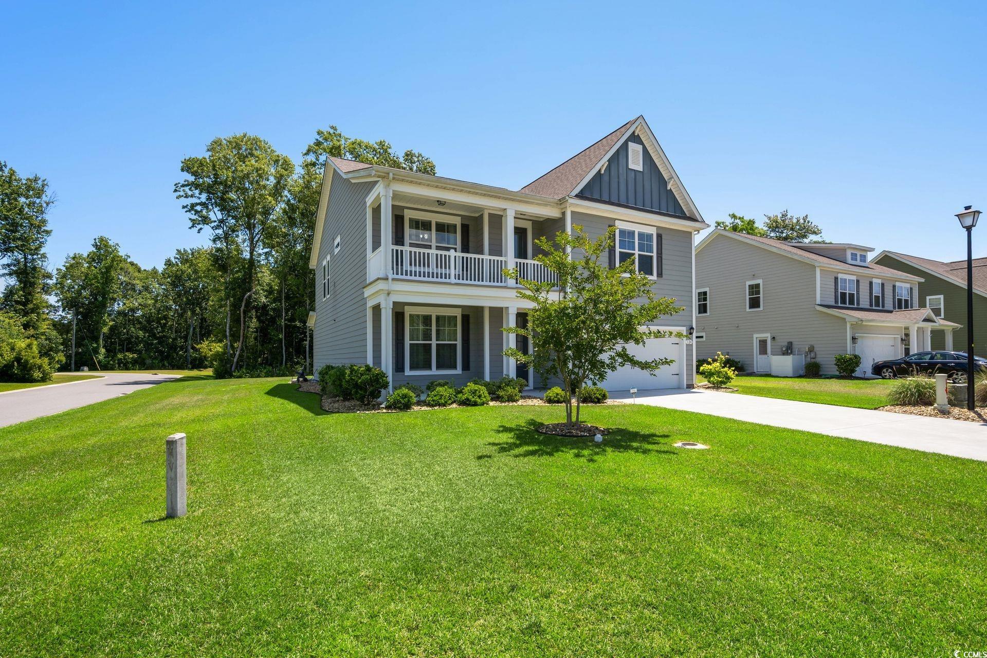 View of front of property featuring a balcony, a f