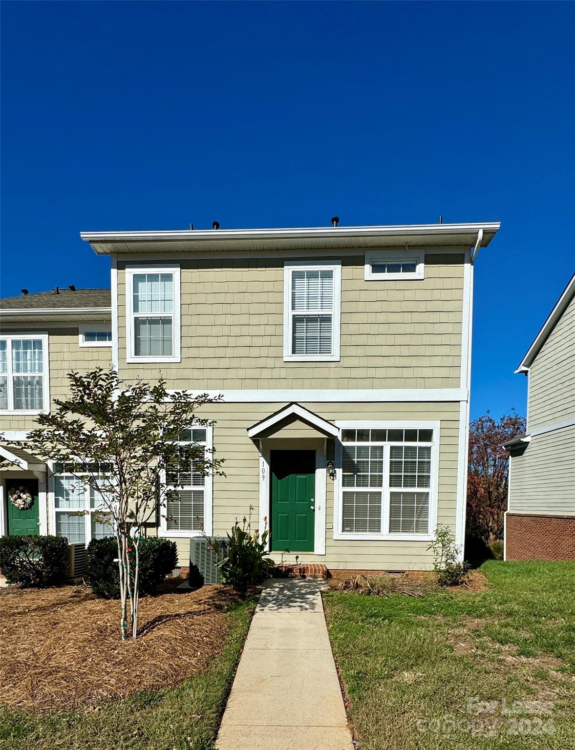 a front view of a house with a yard