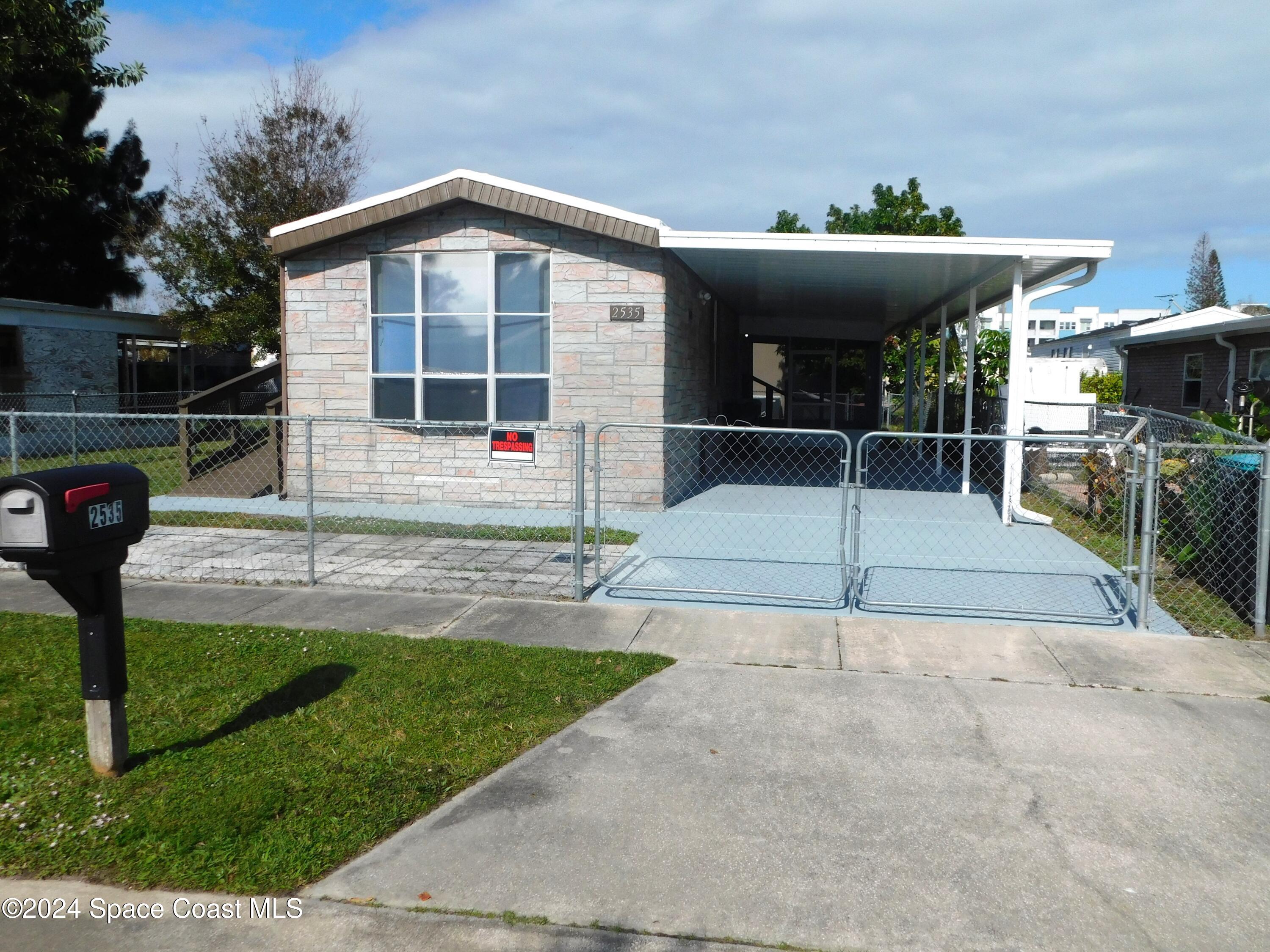 a view of a house with backyard and porch