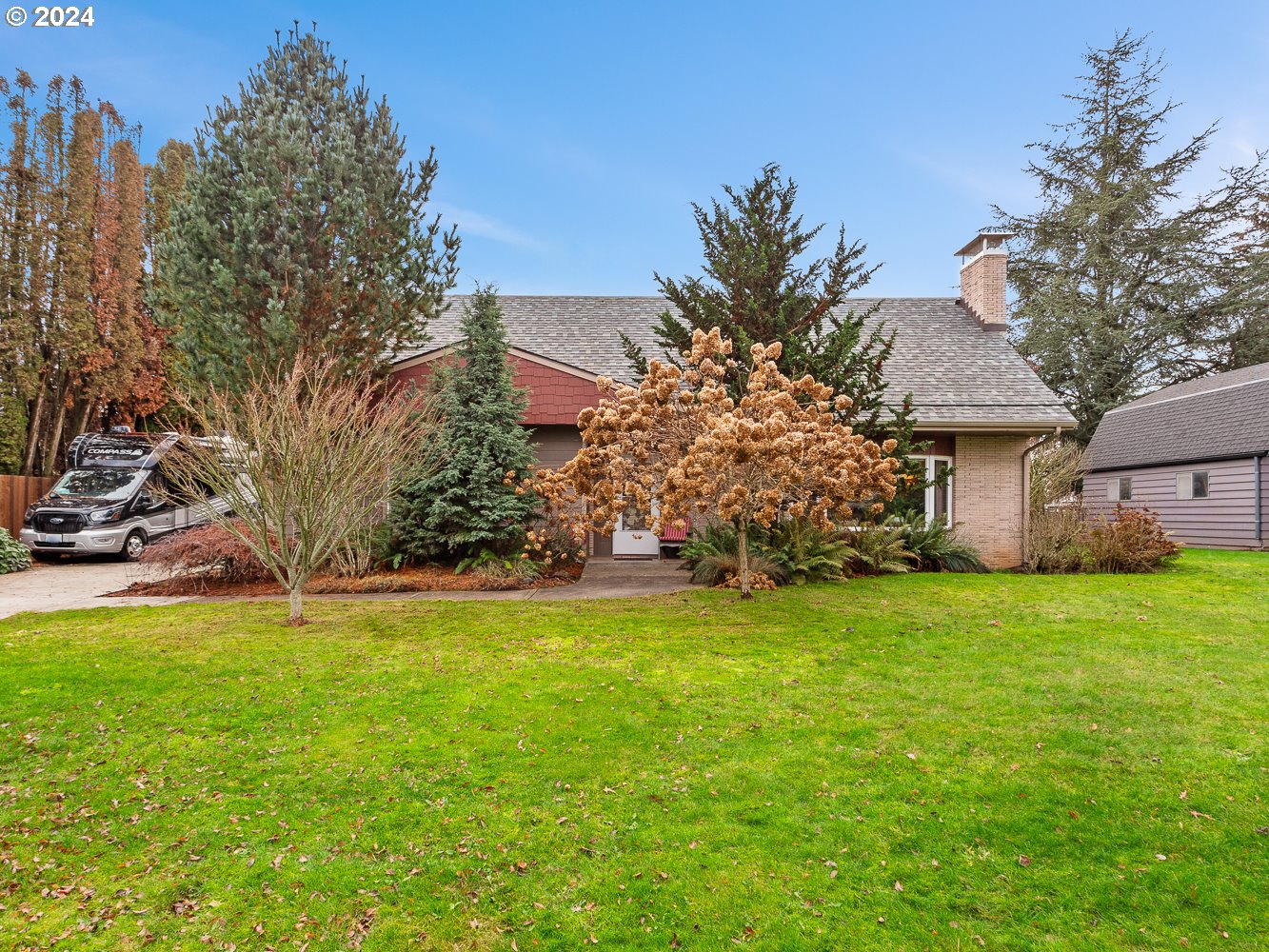 a front view of house with yard and trees