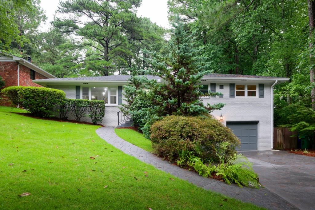 a front view of house with yard and green space