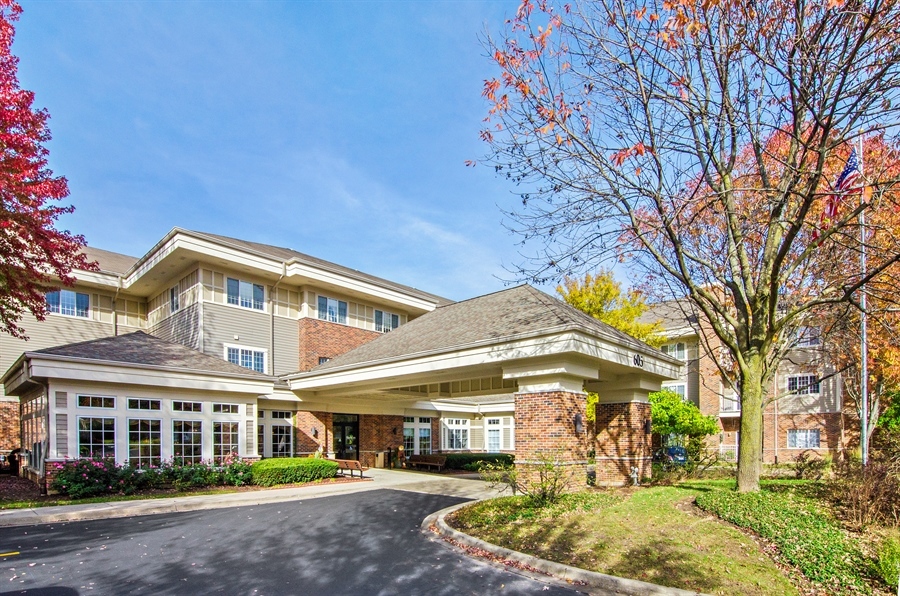 a front view of a building with a garden