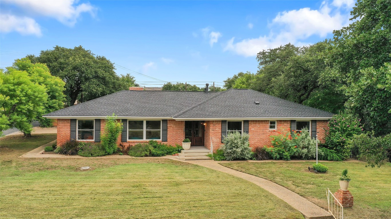 a front view of a house with a garden