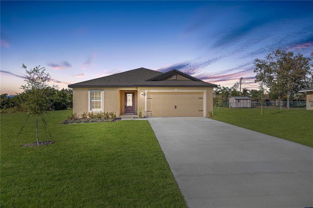 a front view of a house with a yard and garage