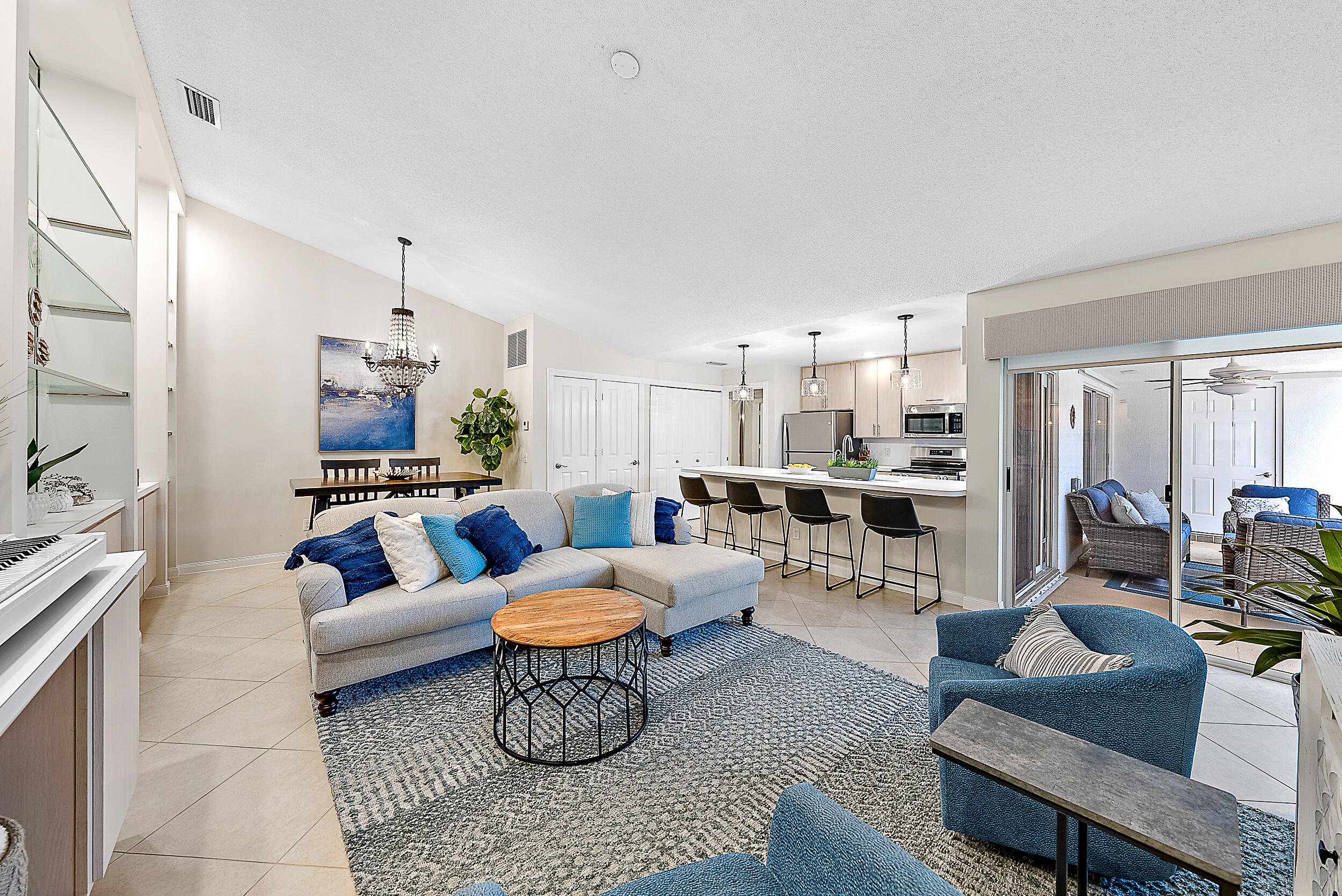 a living room with furniture and kitchen view