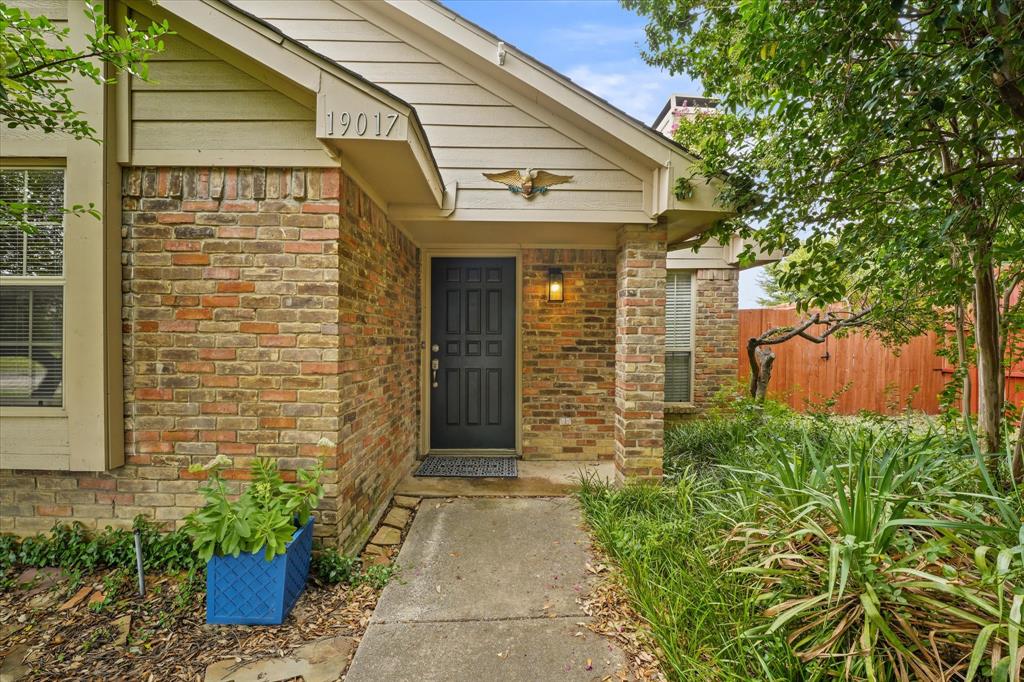 a front view of a house with potted plants