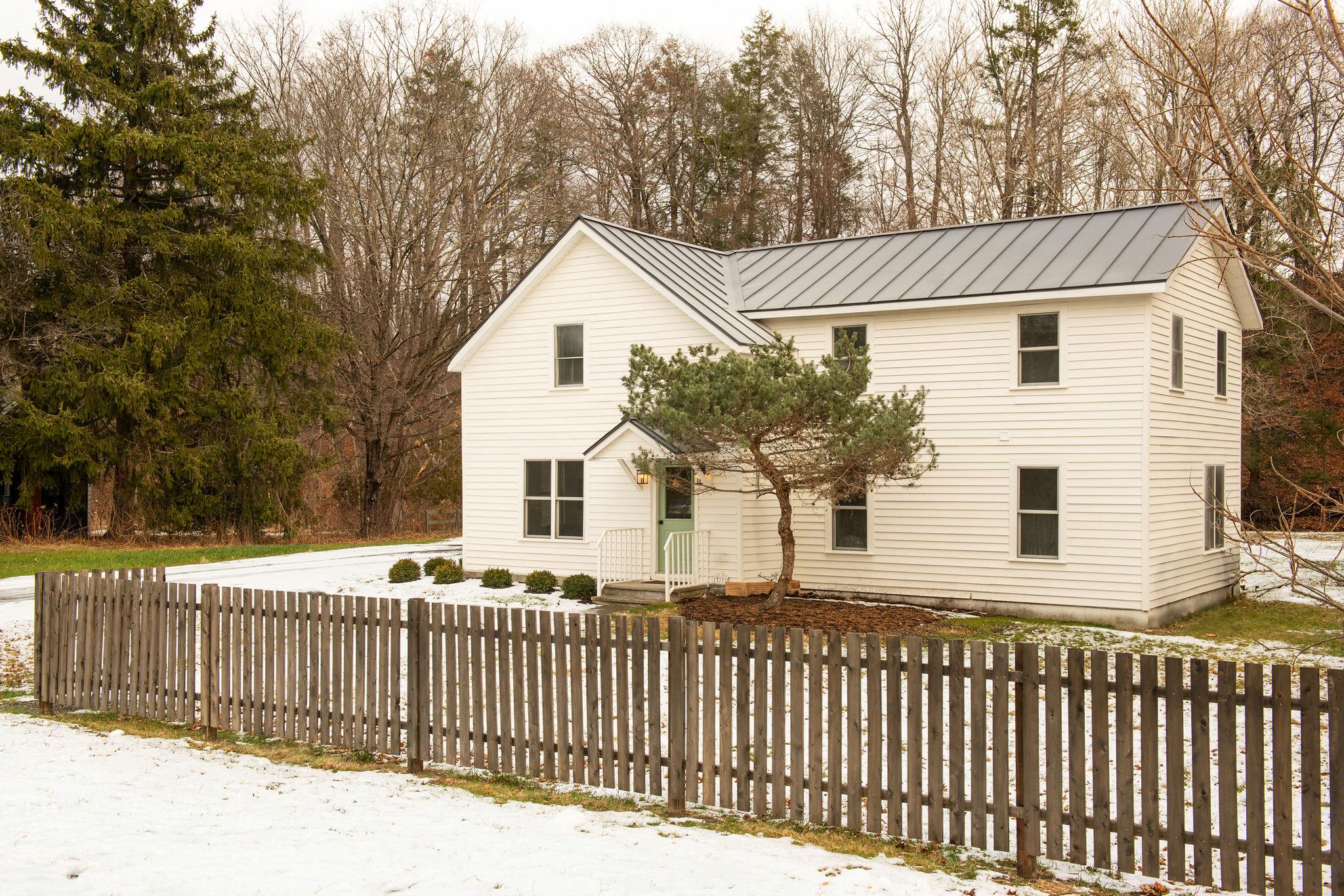 a front view of house with wooden fence