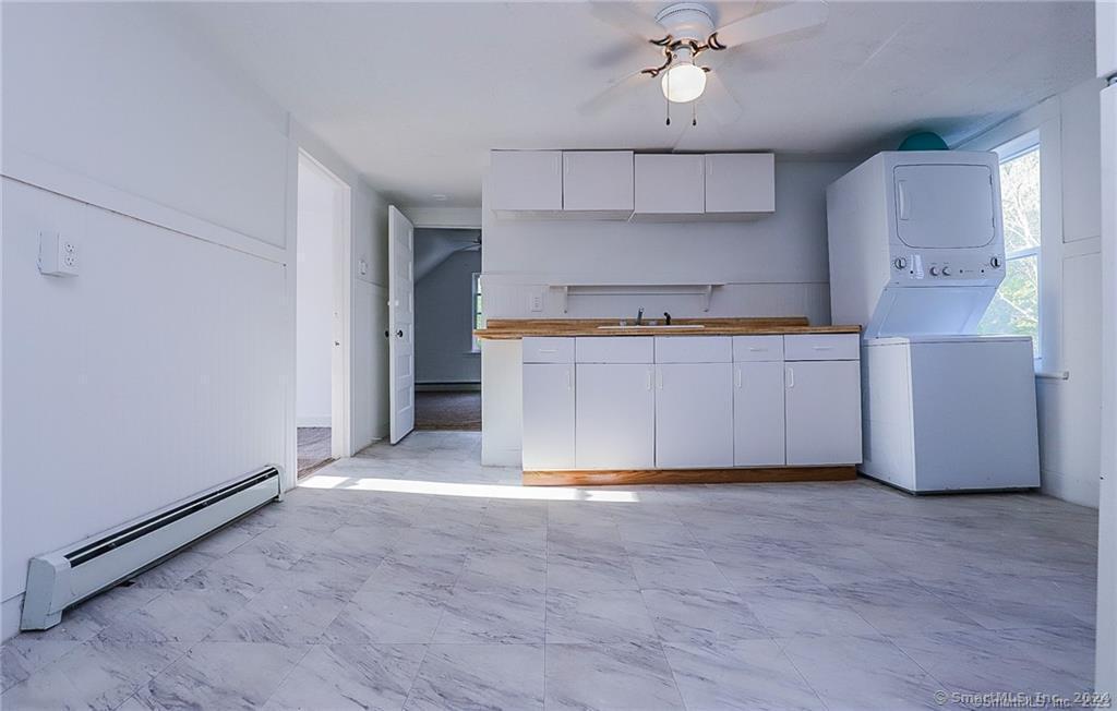 a view of a kitchen with a sink and cabinets