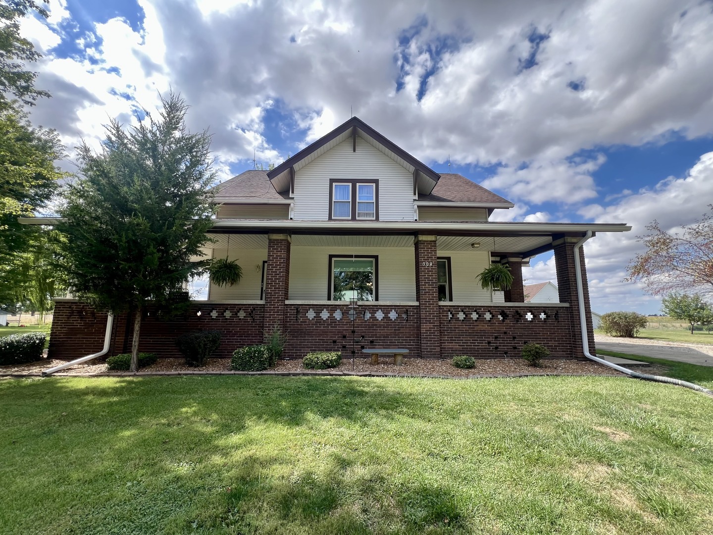 a front view of house with yard and green space