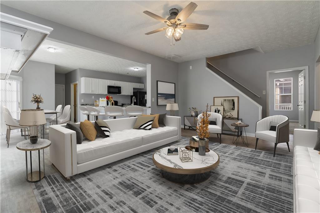 a living room with furniture and a chandelier