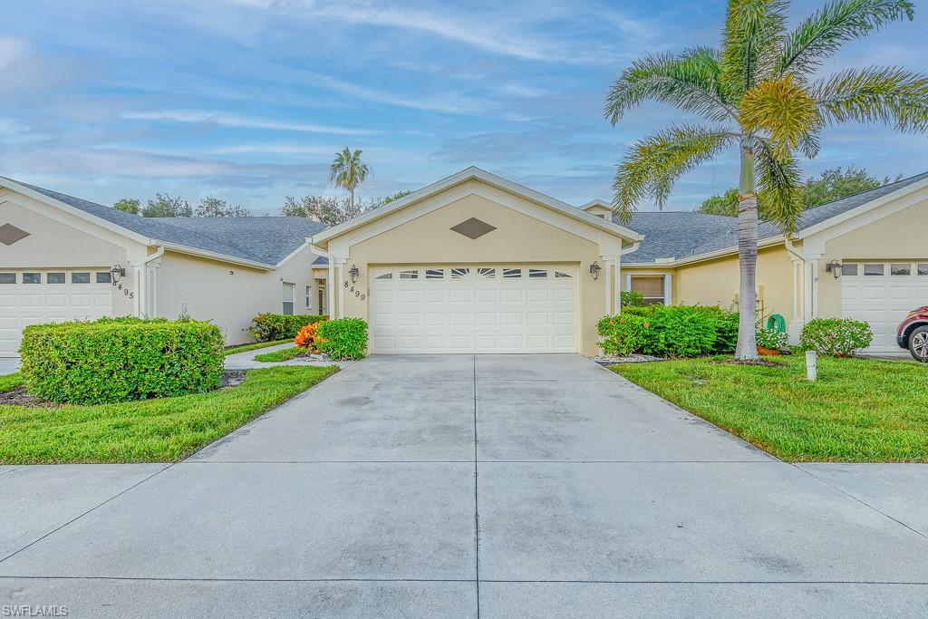 Single story home featuring a front yard and a garage