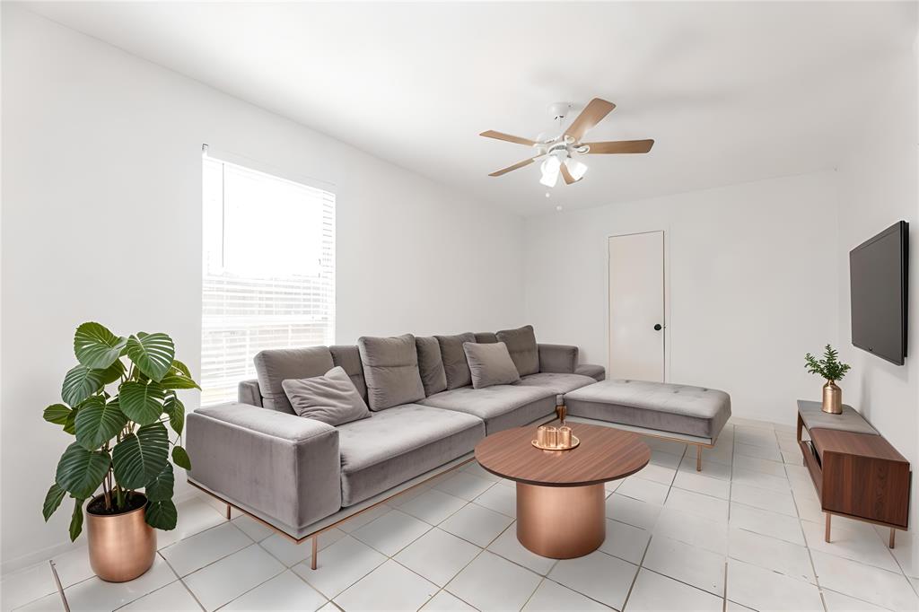 a living room with furniture and a potted plant