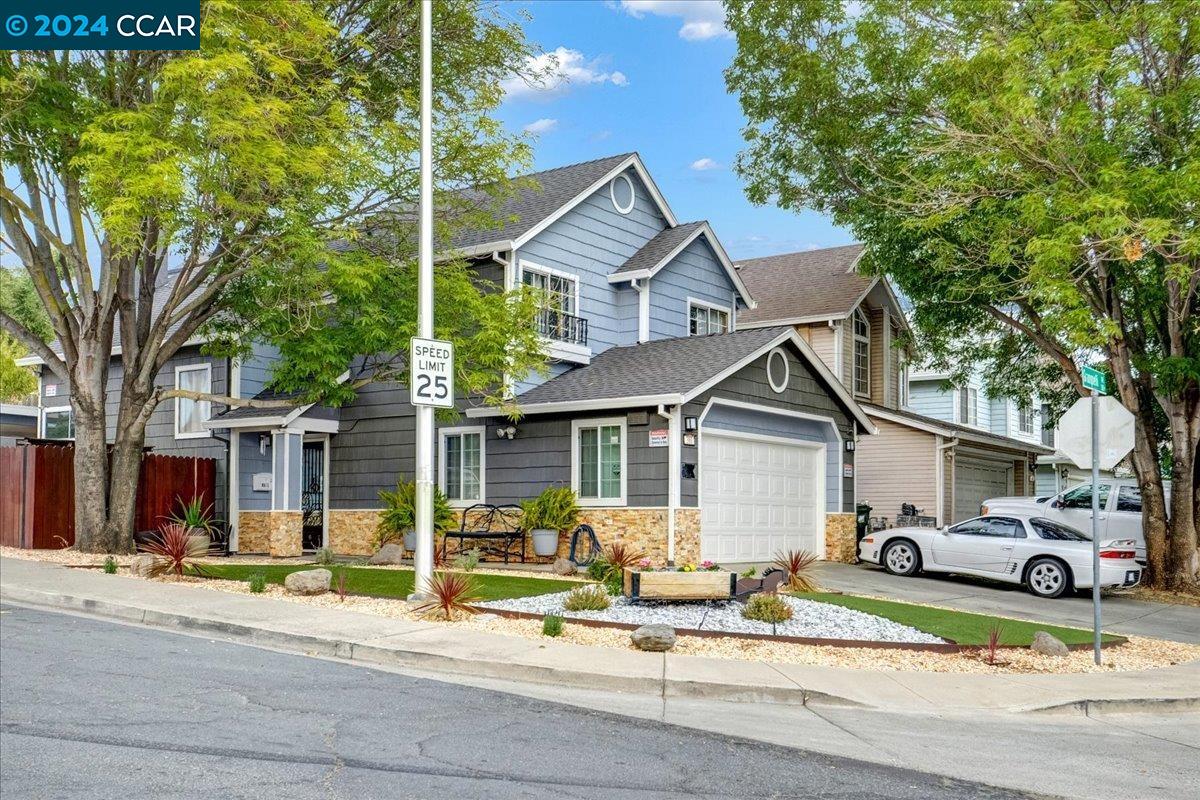 a view of a house with a patio and a yard