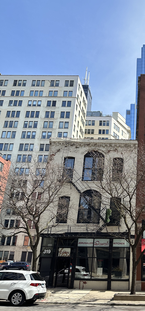 a view of a building and car parked