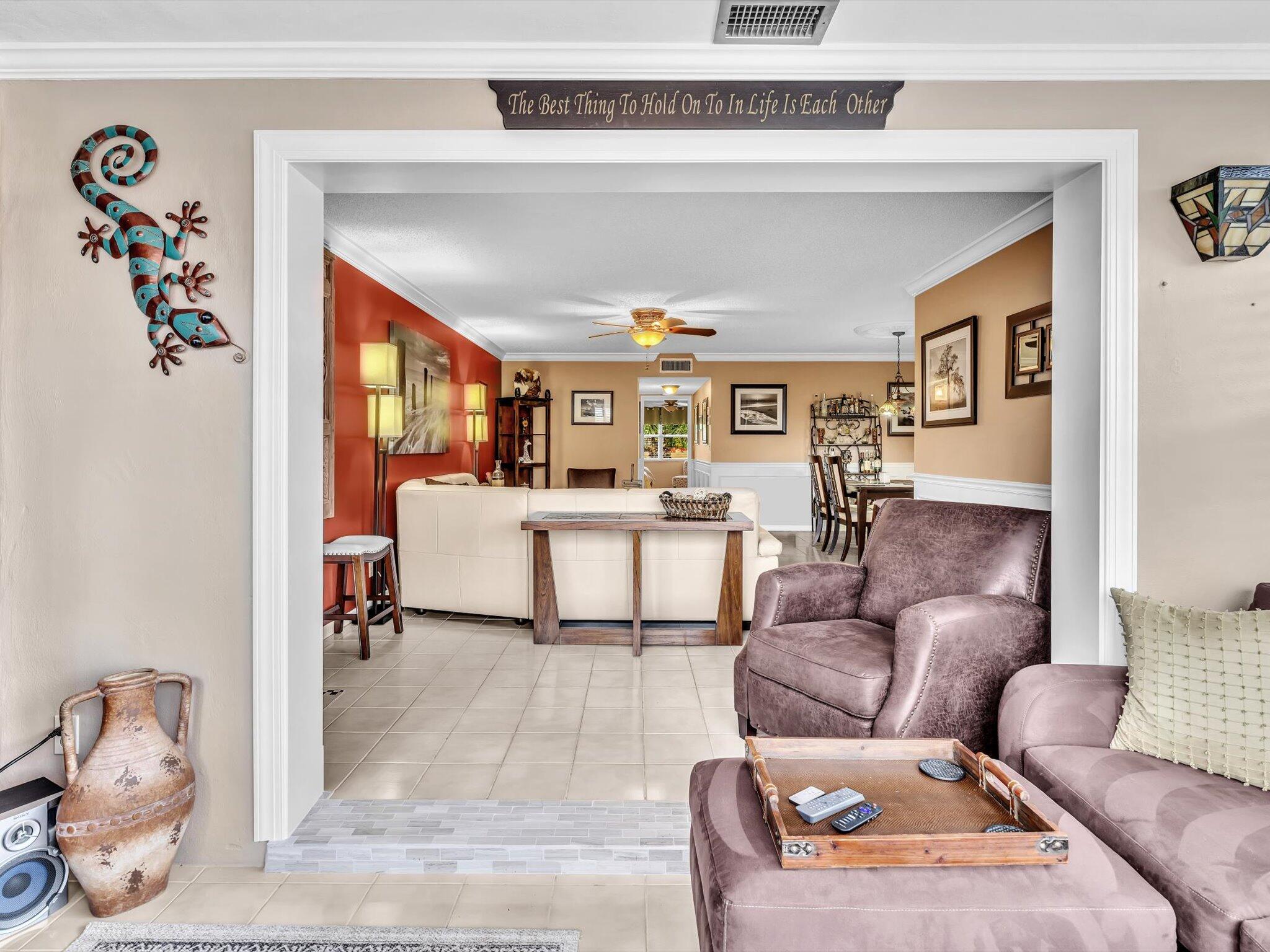 a living room with furniture and a potted plant