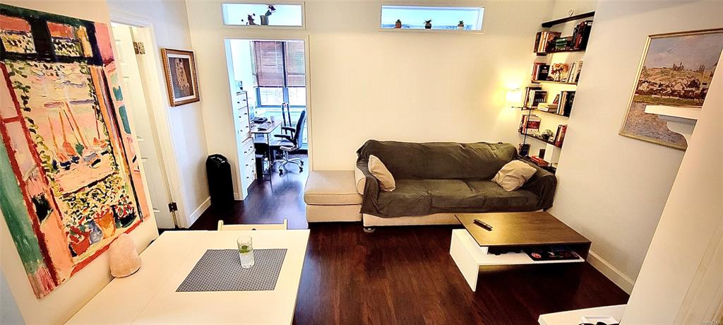 Living room with dark hardwood / wood-style flooring