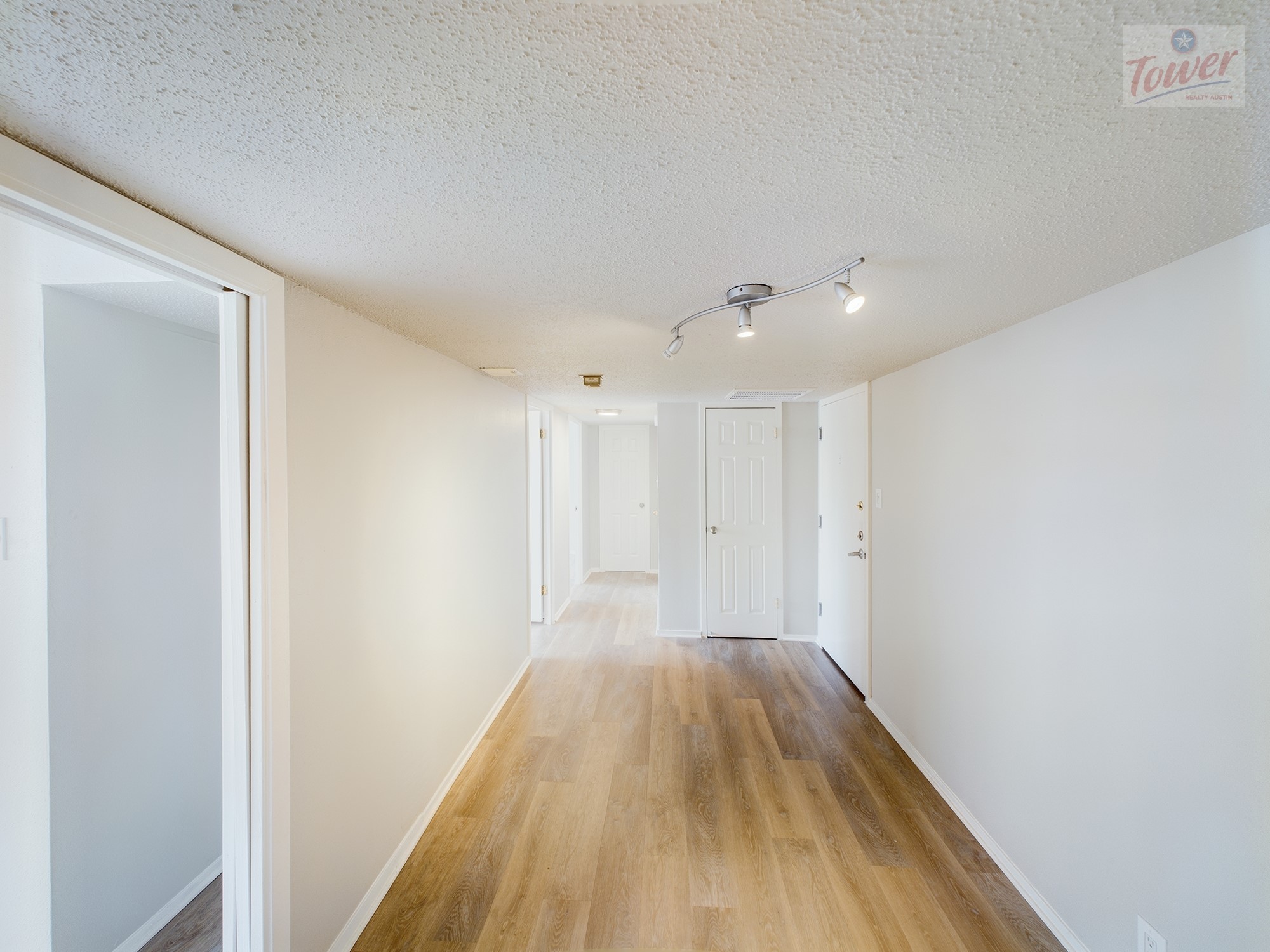 a view of hallway with wooden floor