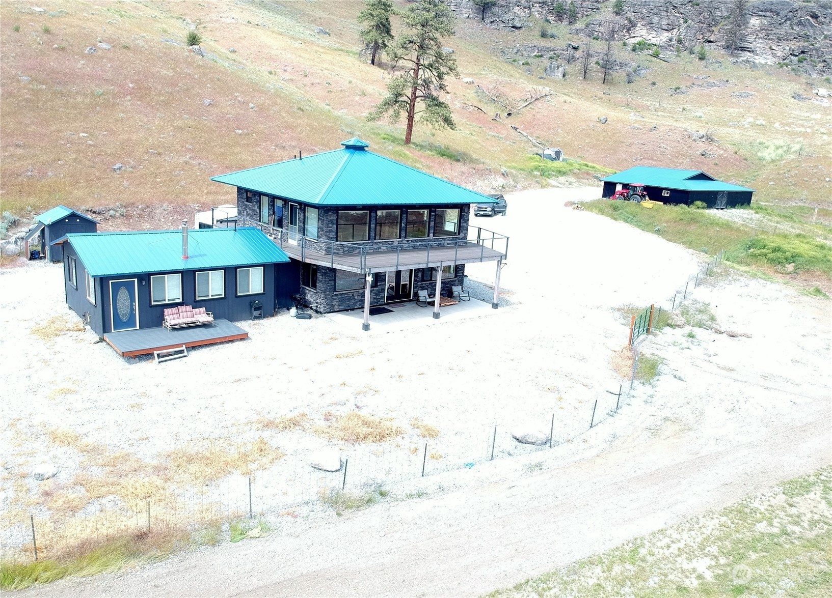 a view of house with yard and sitting area