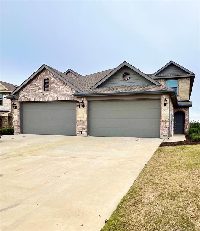 a front view of a house with a garage