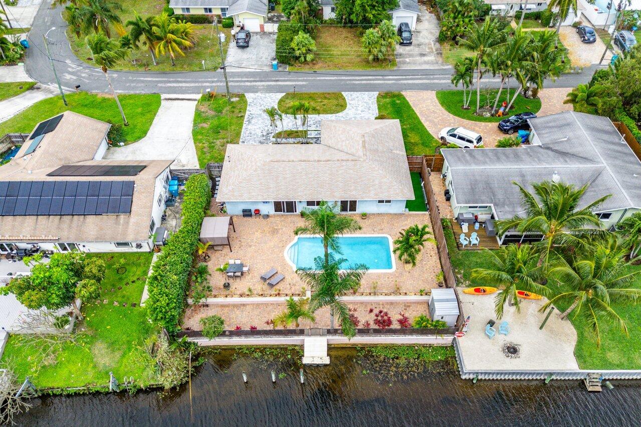 an aerial view of a house with a garden and swimming pool