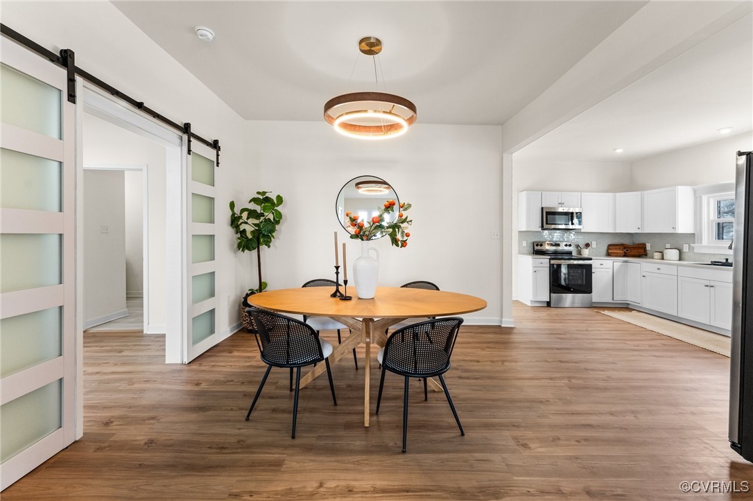 a view of a dining room with furniture and wooden floor