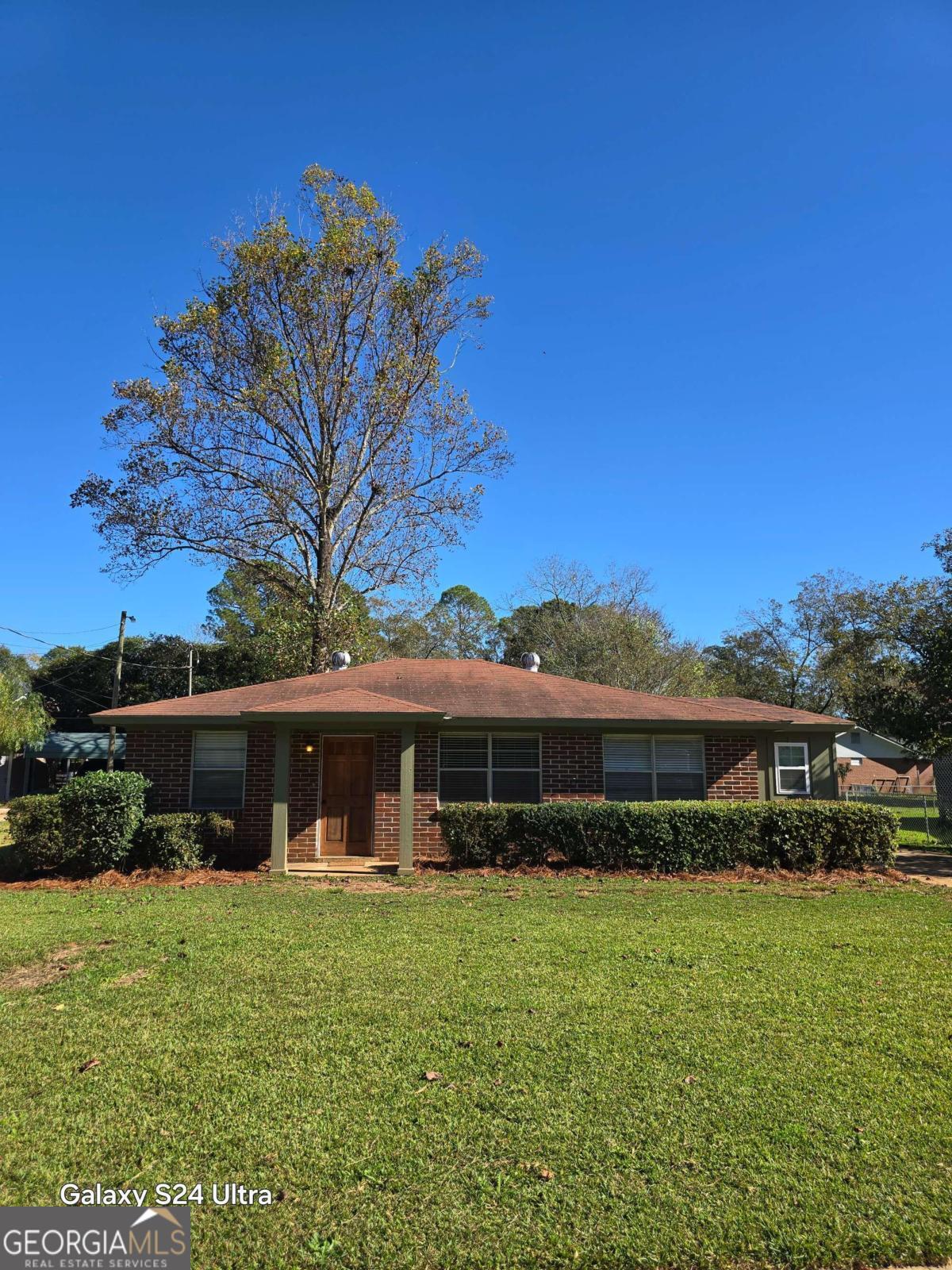 a front view of a house with a garden