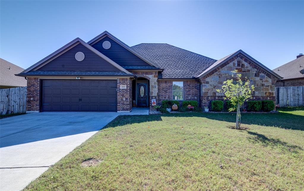 View of front of house with a front lawn and a garage