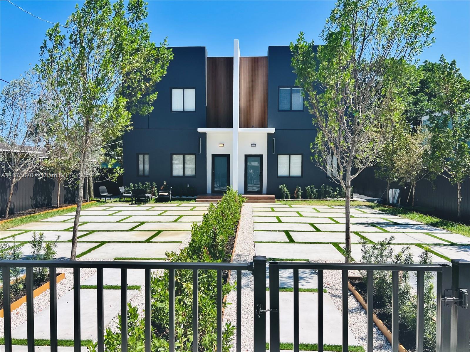 a view of a house with a yard from a balcony