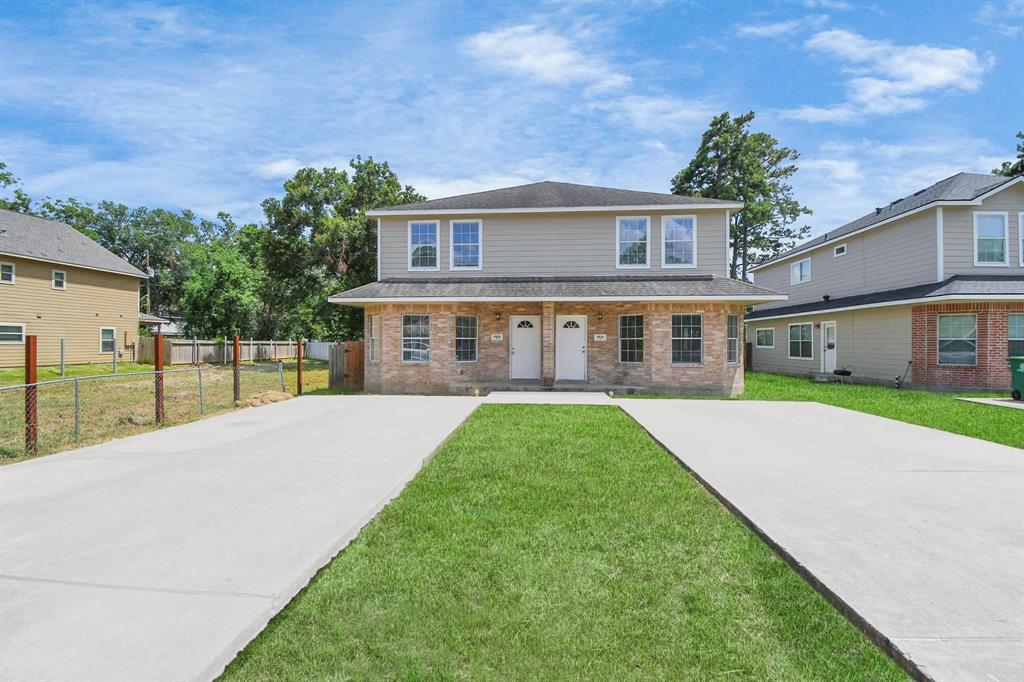 a view of house with yard and green space