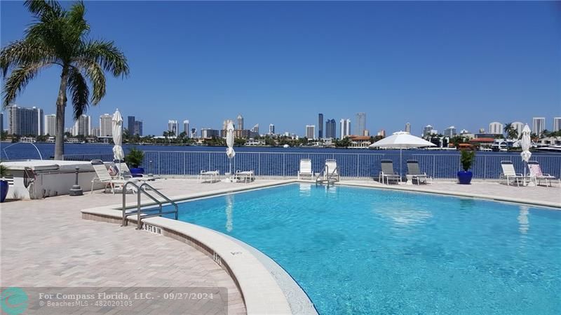 a view of a swimming pool and lounge chairs