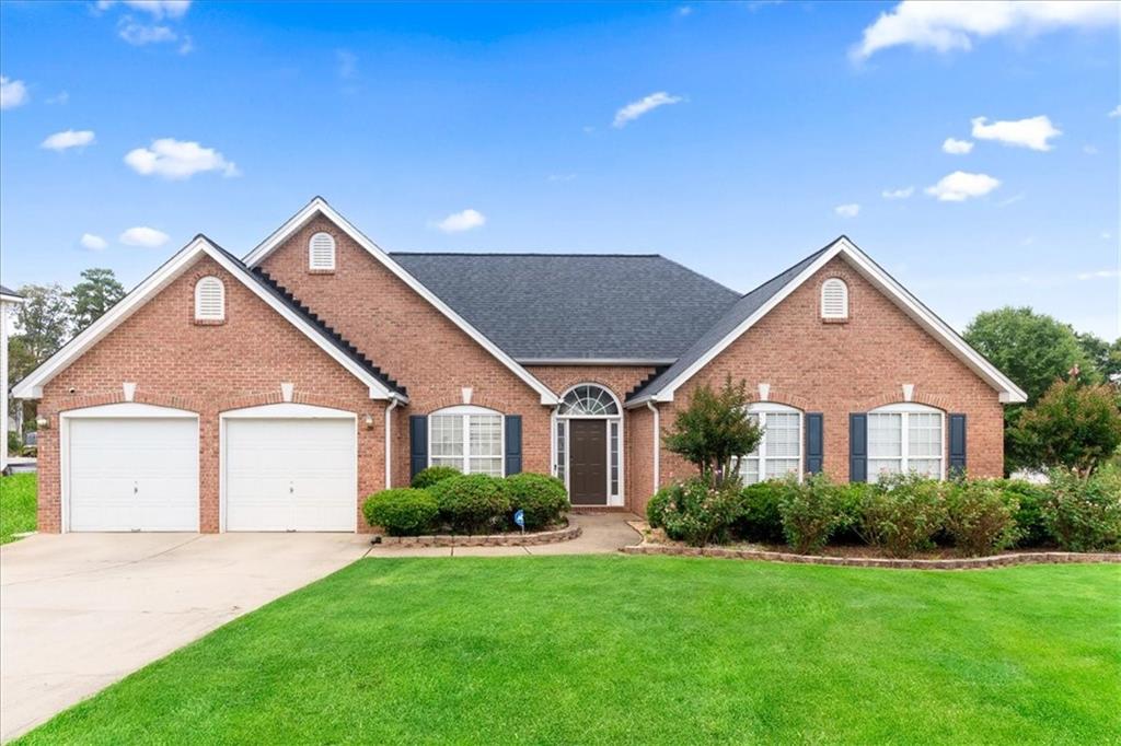 a front view of a house with a yard and garage