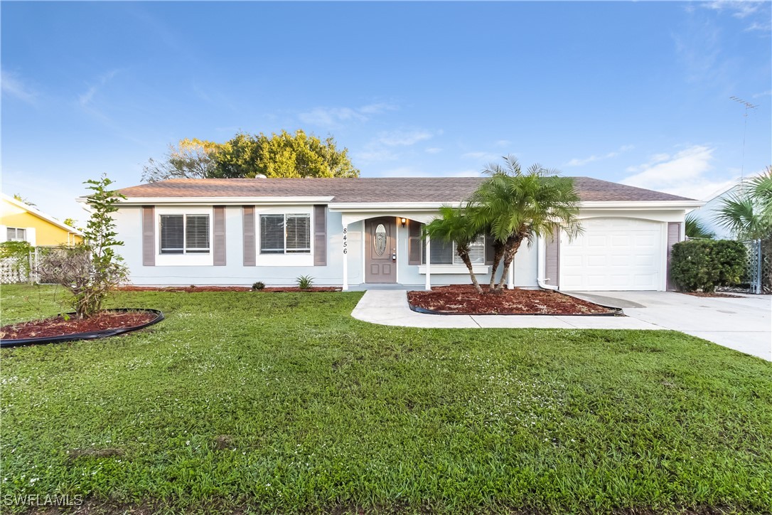 a front view of house with yard and green space