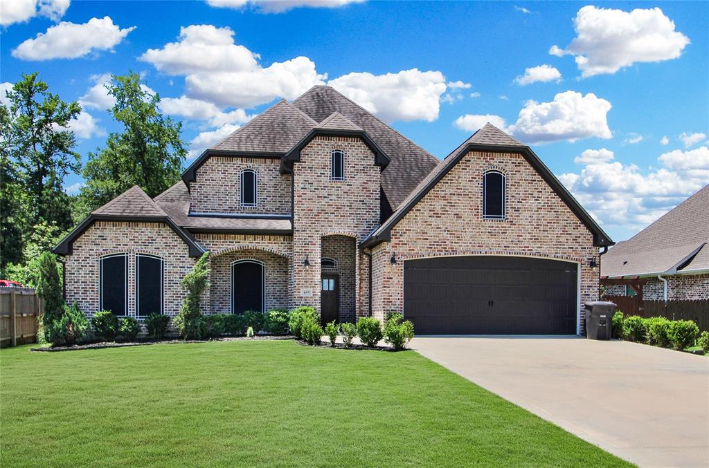 a front view of a house with a garden and entryway