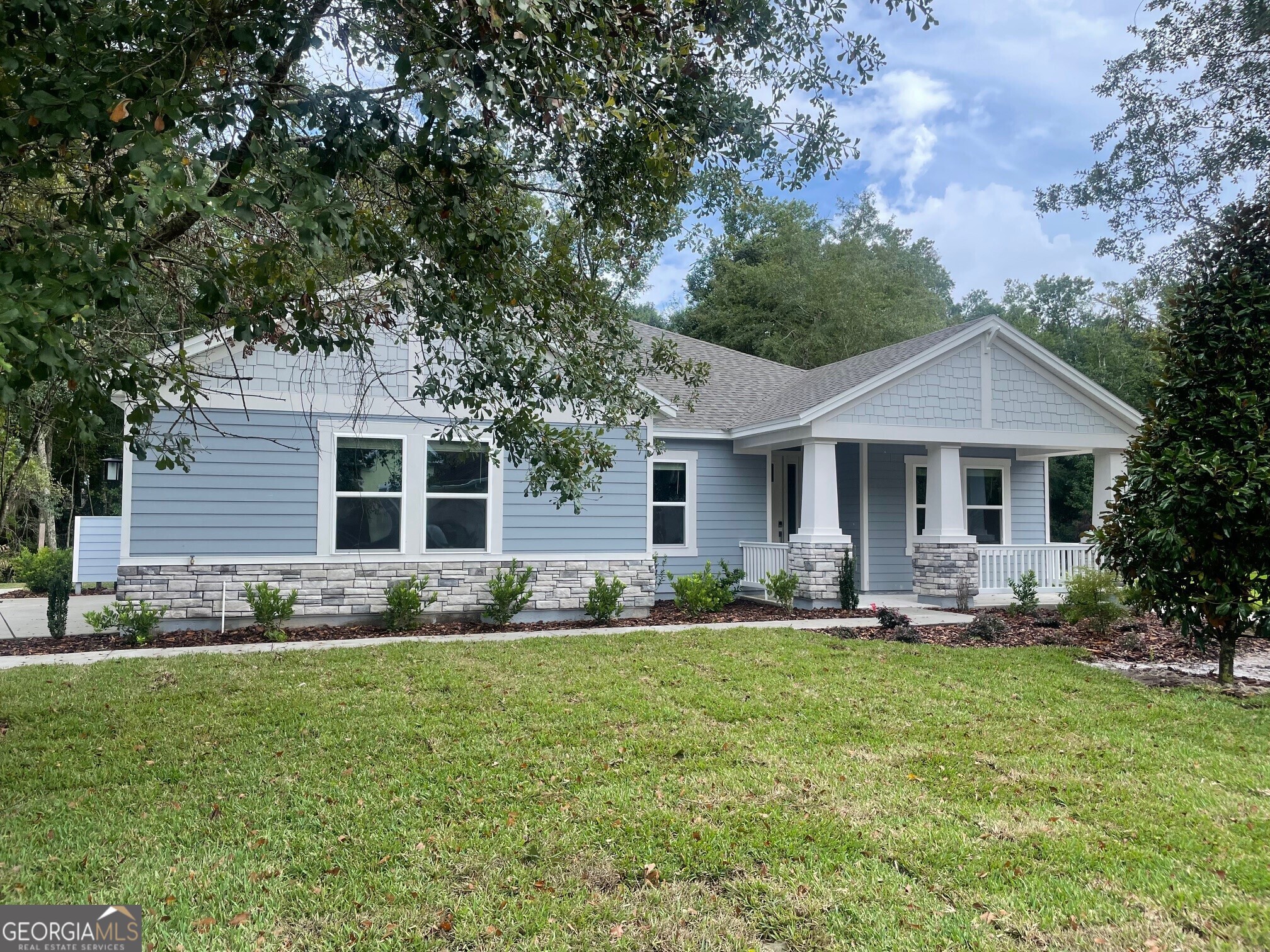 a front view of house with yard outdoor seating and green space