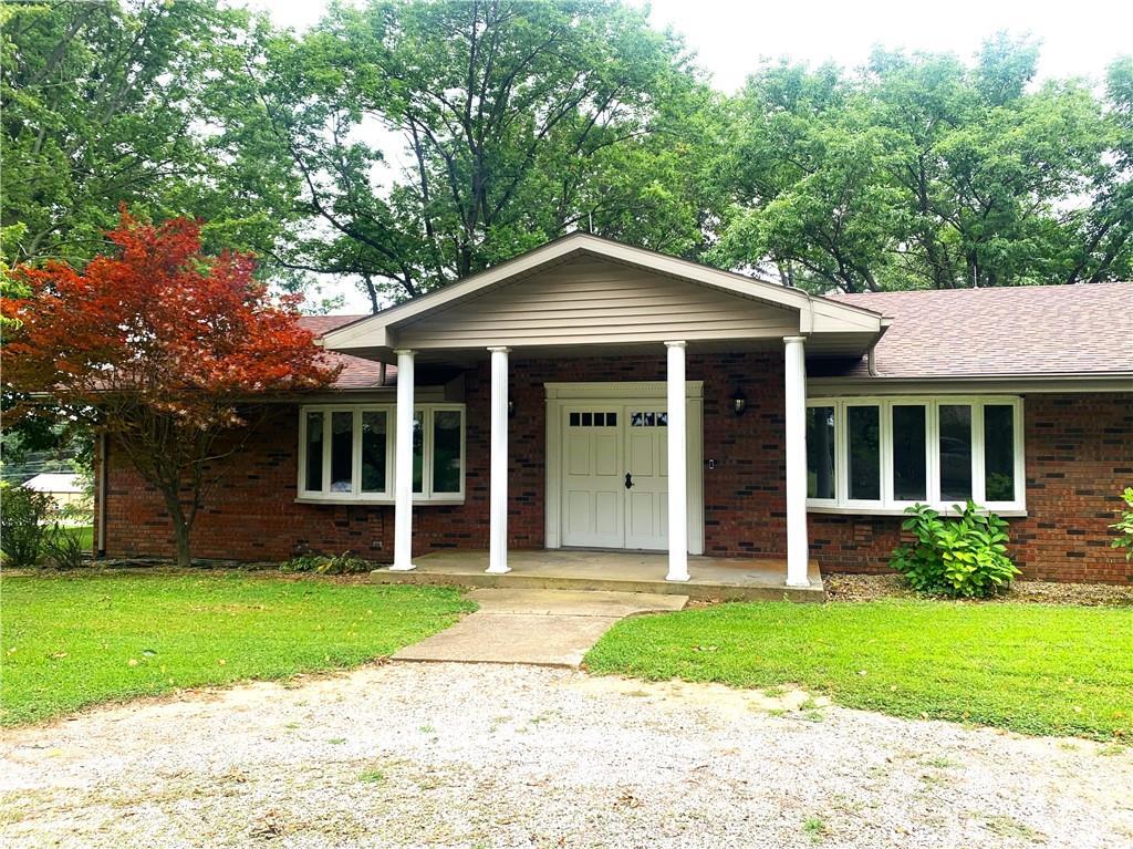 a front view of a house with a yard and porch