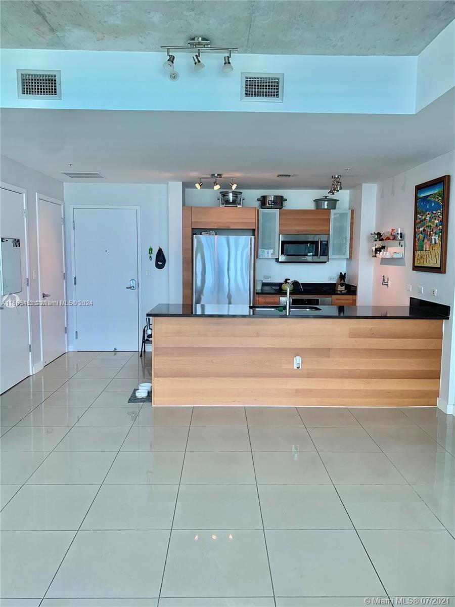 a view of kitchen with furniture and flat screen tv