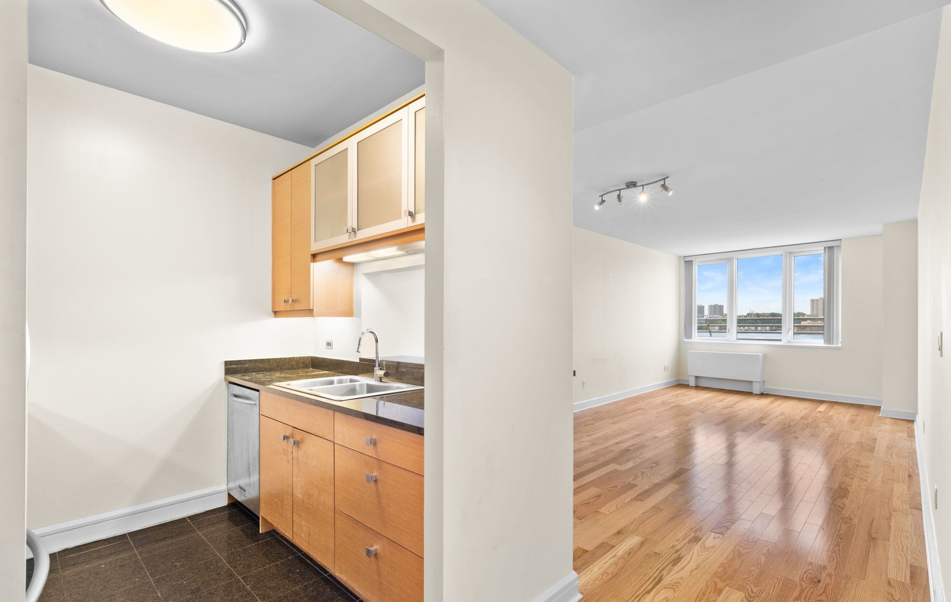 a kitchen with granite countertop a stove and a sink