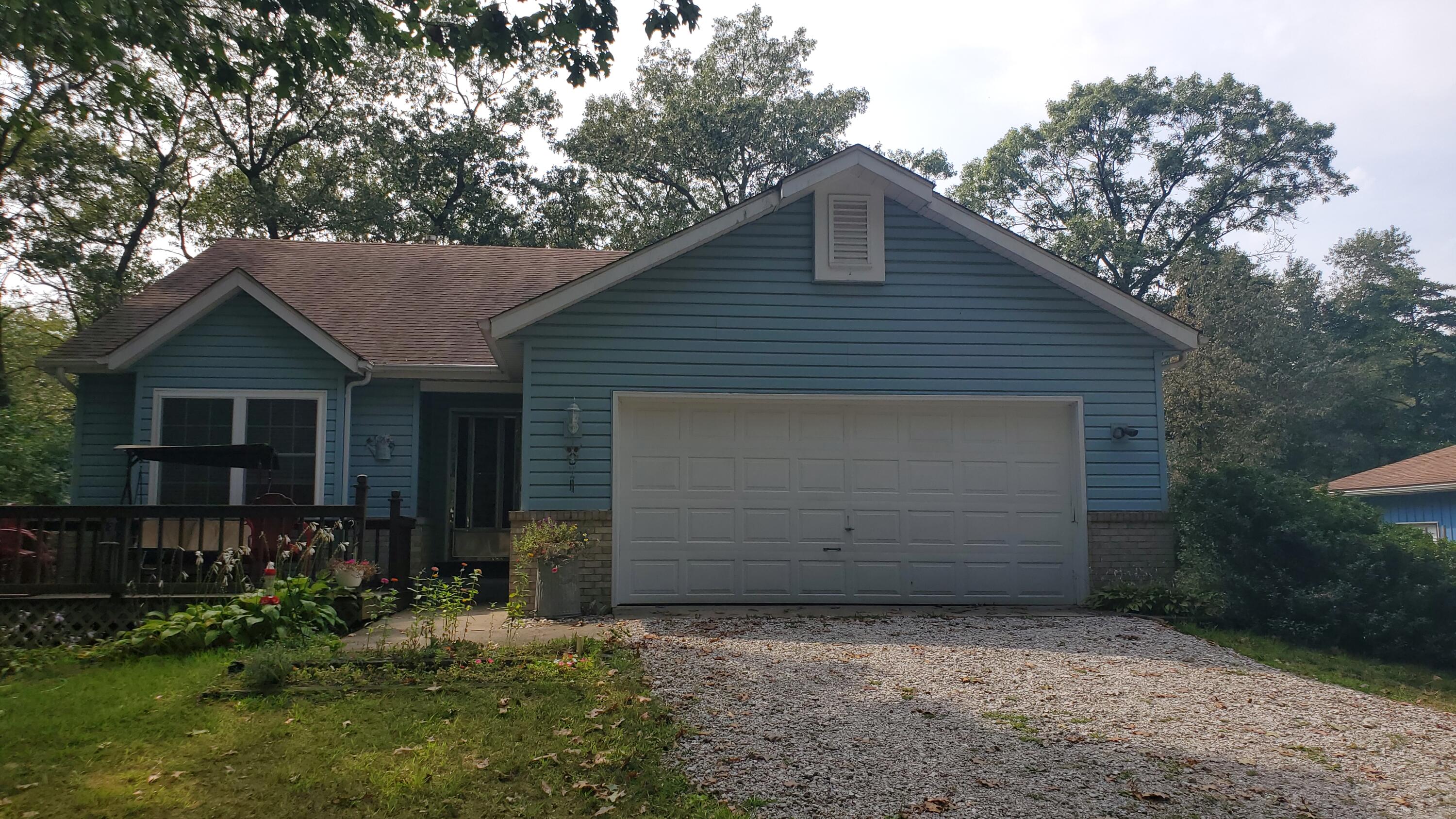 a front view of house with yard and trees