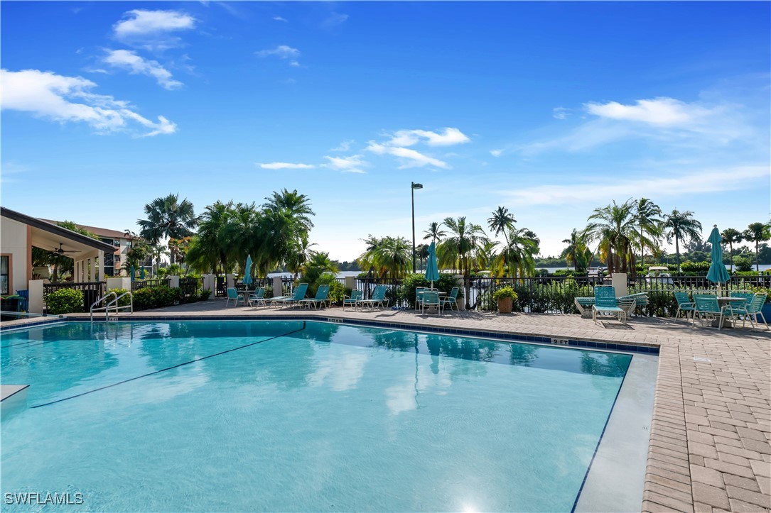 a swimming pool with outdoor seating and yard