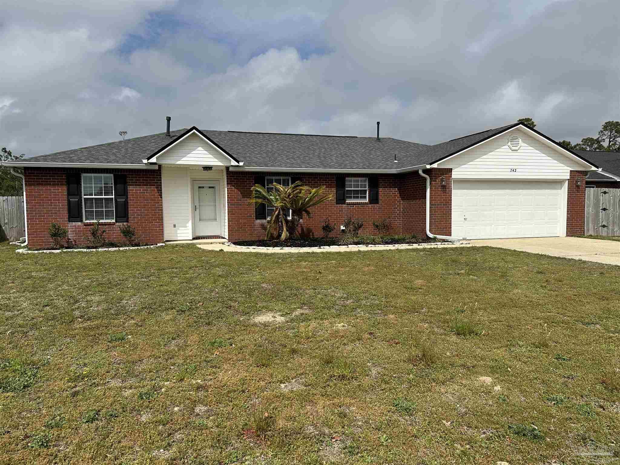 a front view of a house with yard