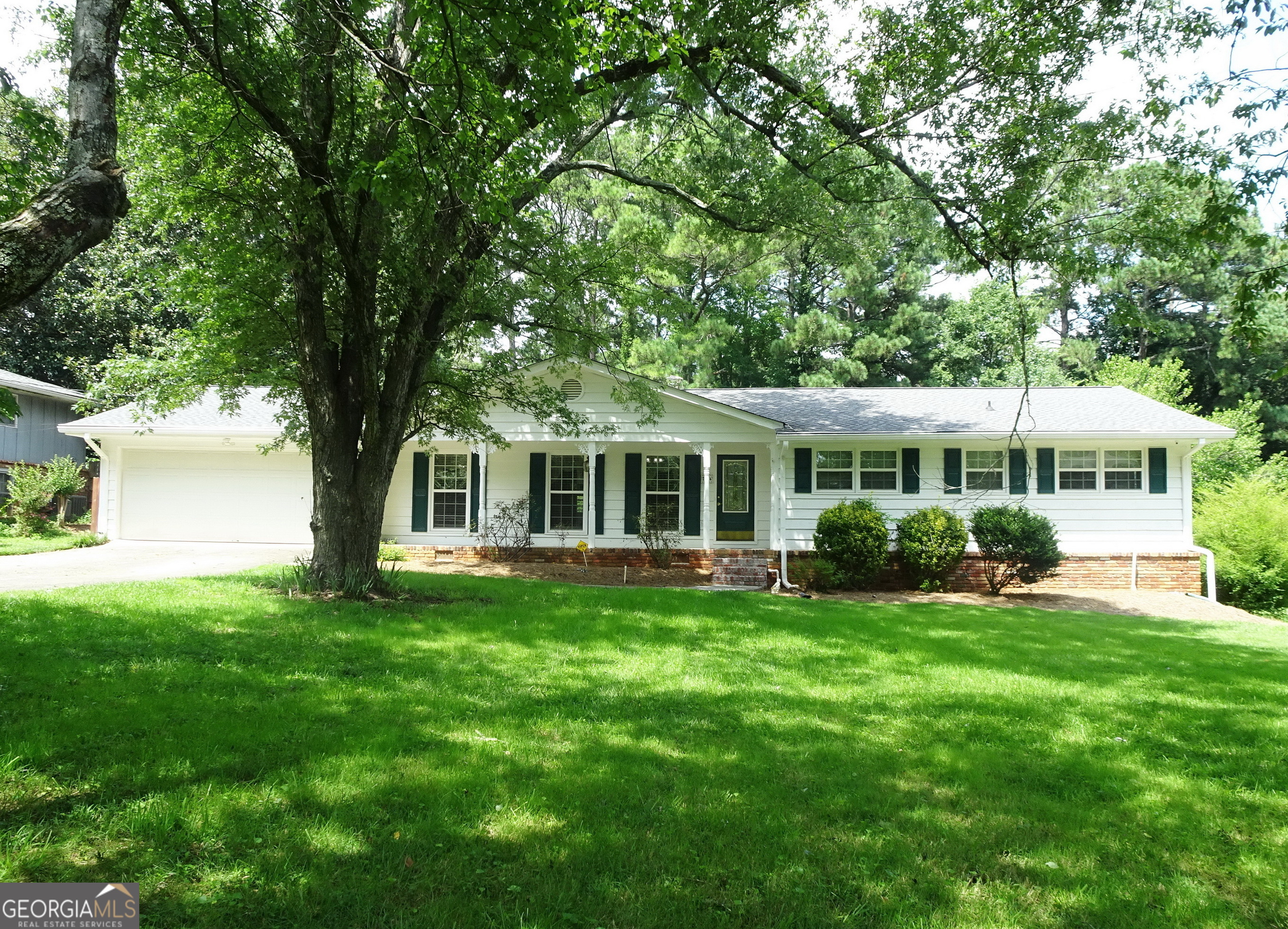 a front view of a house with a garden