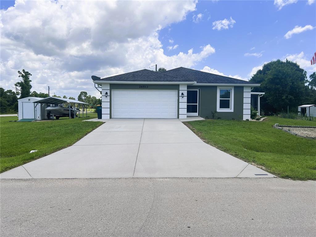 a front view of a house with a yard and garage