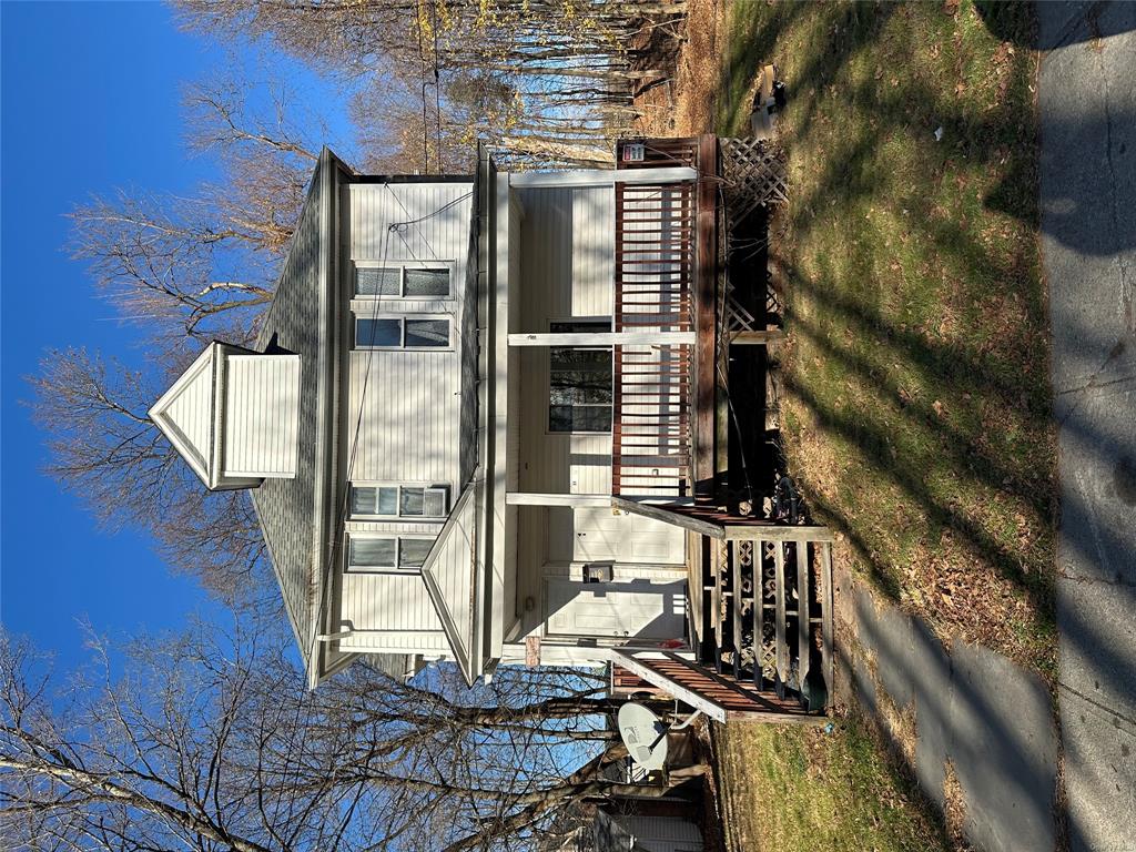 View of front of home with a front yard and a porch