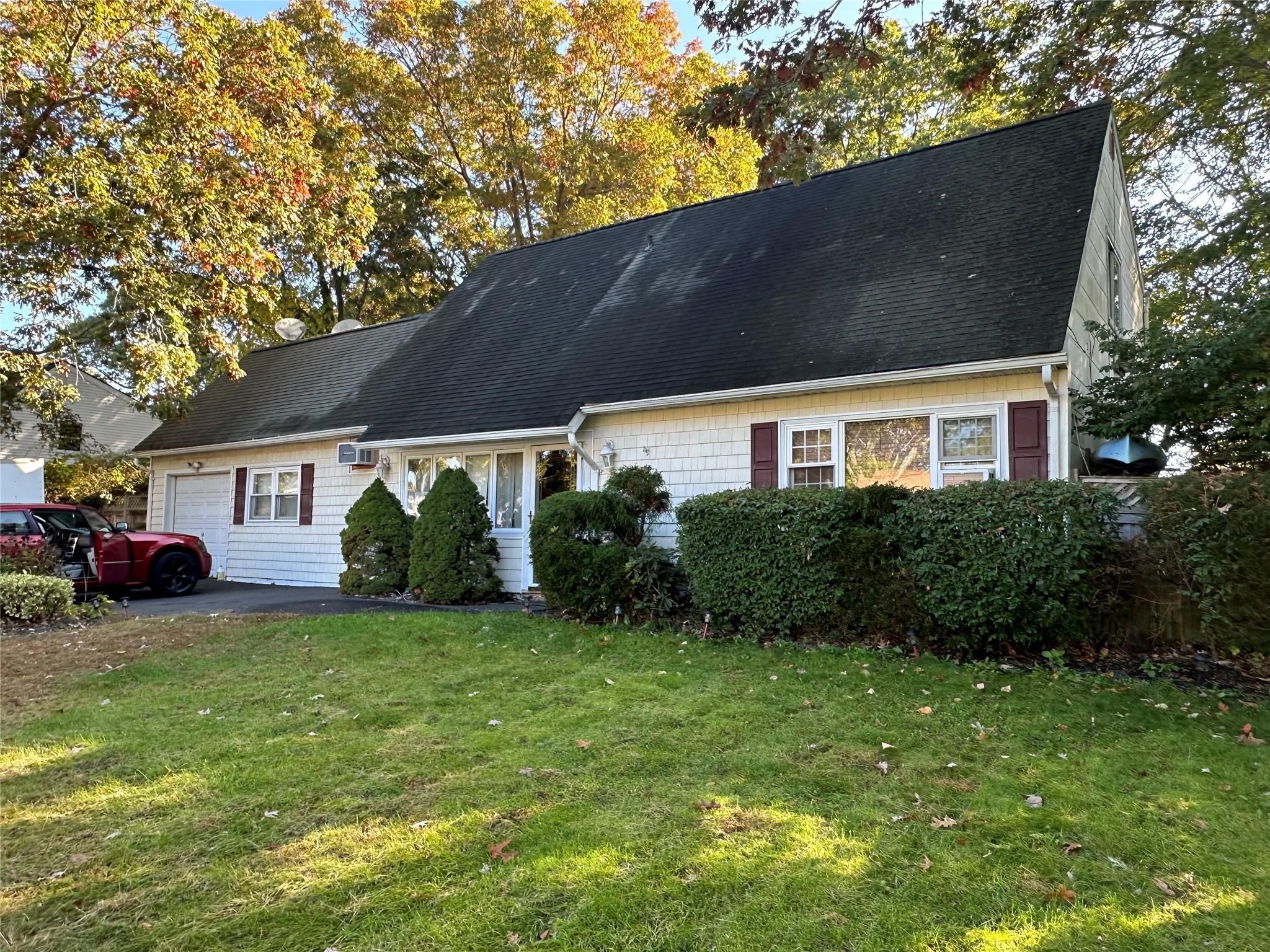 a view of a house with a yard and garage