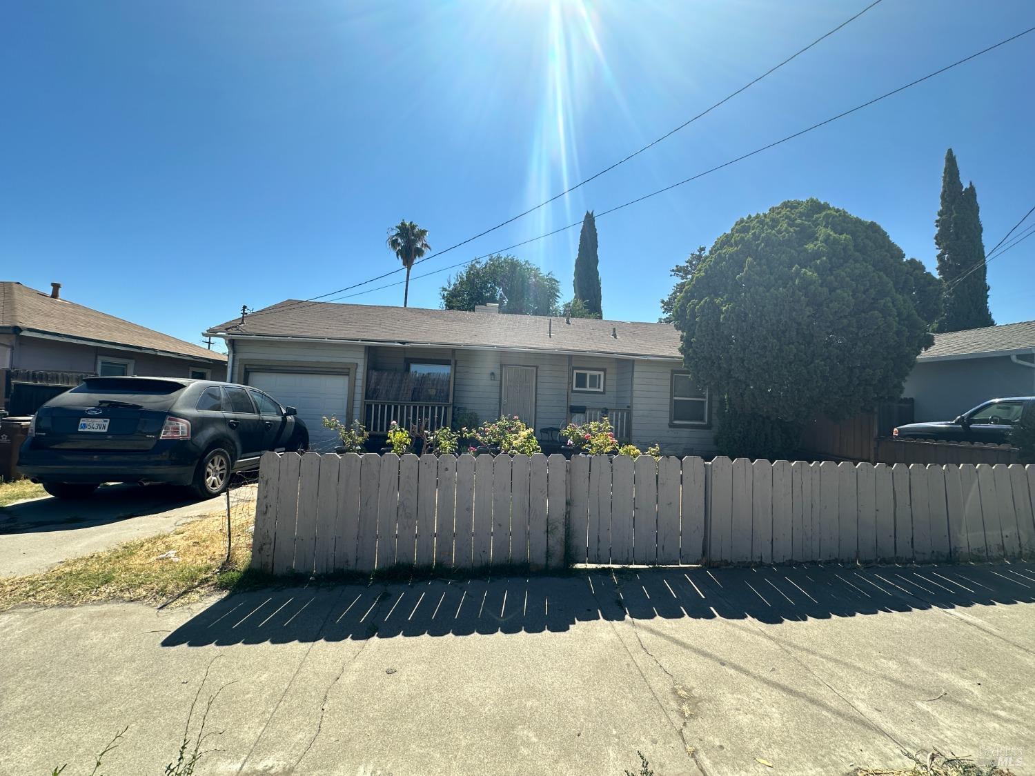 a view of a house with a wooden fence