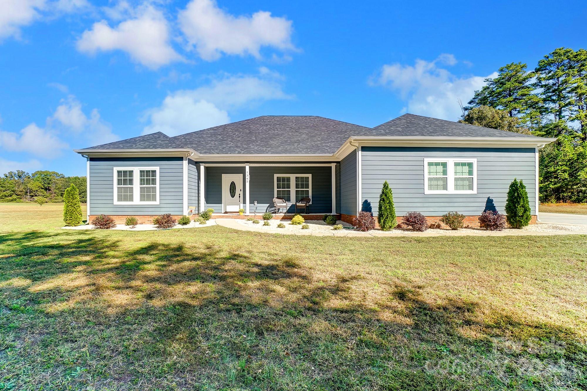 a front view of house with yard and green space